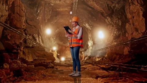 Female Engineer Taking Note On The Tablet In Mine Tunnel Stock Footage 299580437