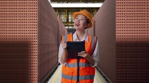 Female Engineer Taking Note On The Tablet With Brick In Stacks Stock Footage 303761789