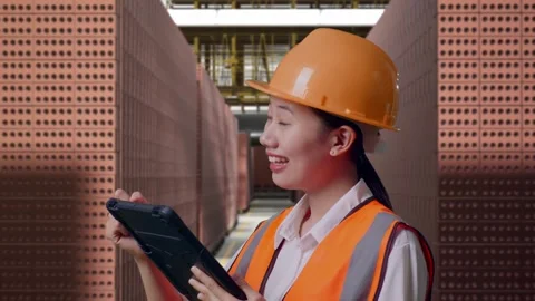 Female Engineer Taking Note On The Tablet With Brick In Stacks Stock Footage 303762629
