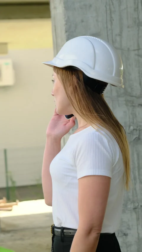 Female engineer talk on smartphone standing on construction site Stock Footage 317622767