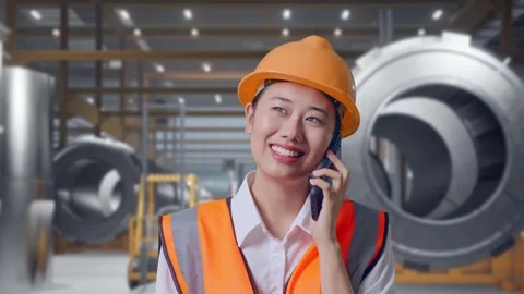 Female Engineer Talking On Smartphone at Heavy Factory Stock Footage 340825102
