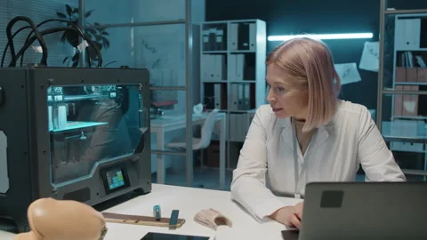 Female Engineer Testing Printing Machine with Laptop Stock Footage 257711520