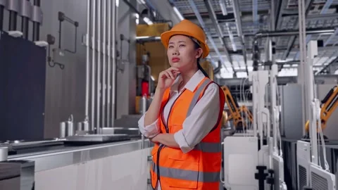 Female Engineer Thinking Then Raising Her Index Finger, Battery Factory Stock Footage 314936159