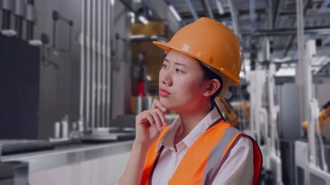 Female Engineer Thinking Then Raising Her Index Finger, Battery Factory Stock Footage 314936690