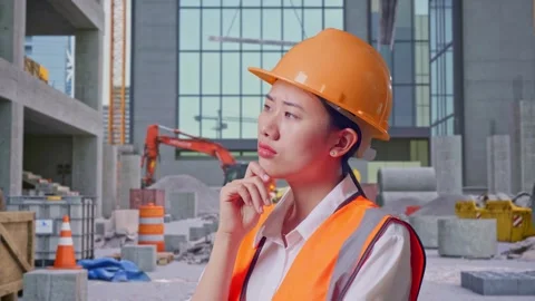 Female Engineer Thinking Then Raising Her Index Finger at Construction Site Stock Footage 325858027