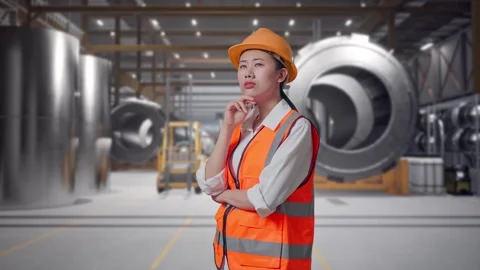 Female Engineer Thinking Then Raising Her Index Finger at Heavy Factory Stock Footage 340824096