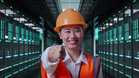 Female Engineer Touching Her Chest Then Pointing in Data Center Video stock 321994259
