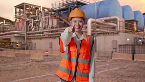 Female Engineer Touching Her Chest Then Pointing at Gas Plant Stock Footage 337762446