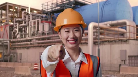 Female Engineer Touching Her Chest Then Pointing at Gas Plant Stock Footage 337763133