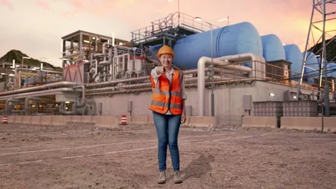Female Engineer Touching Her Chest Then Pointing at Gas Plant Stock Footage 337764158