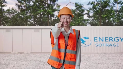 Female Engineer Touching Her Chest Then Pointing with Energy Storage Stock Footage 337818599