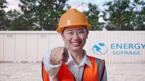 Female Engineer Touching Her Chest Then Pointing with Energy Storage Stock Footage 337819541