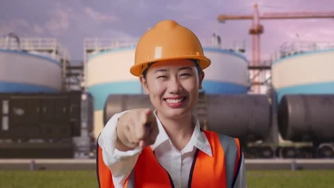 Female Engineer Touching Her Chest Then Pointing at Oil Refinery Stock Footage 340143622