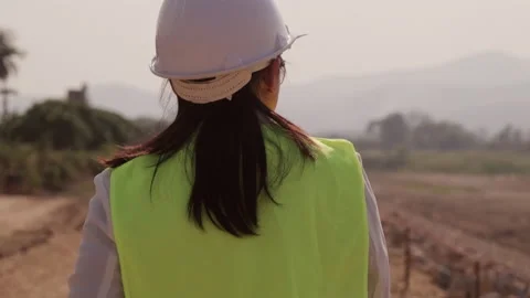 Female engineer uses a digital tablet to work outdoors at a construction site. 스톡 동영상 172412781