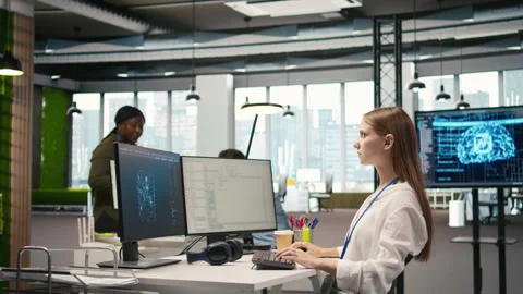 Female engineer using AI LLM chatbot, optimizing company systems 스톡 동영상 313165219