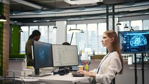 Female engineer using AI LLM chatbot, optimizing company systems 写真素材