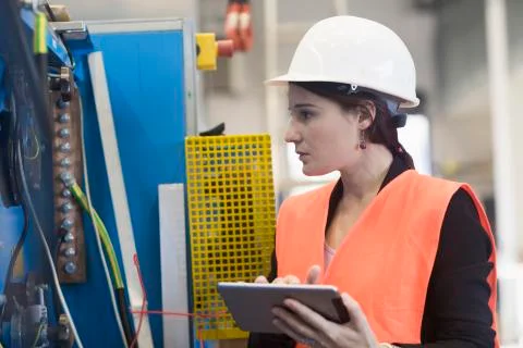 Female engineer using a digital tablet in an industrial plant Stock Photos