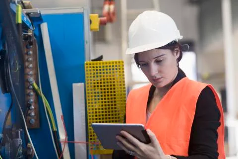 Female engineer using a digital tablet in an industrial plant 스톡 사진