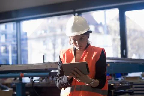 Female engineer using a digital tablet in an industrial plant 写真素材