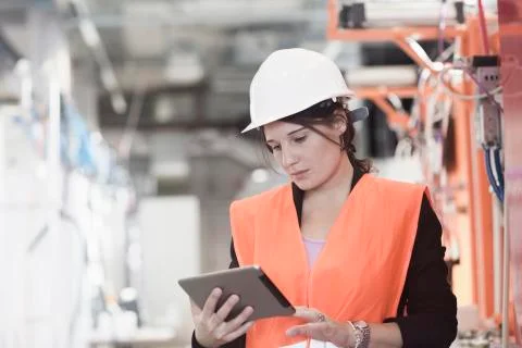 Female engineer using a digital tablet in an industrial plant 写真素材