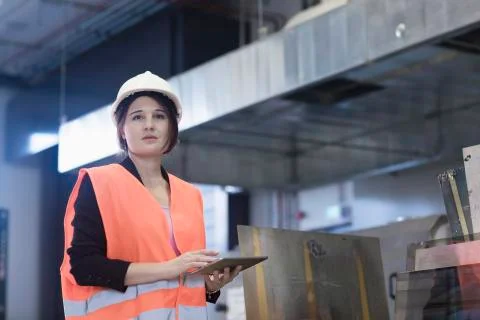 Female engineer using a digital tablet in an industrial plant Stock Photos