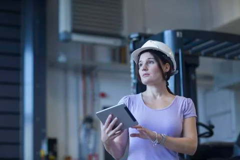 Female engineer using a digital tablet in an industrial plant Stock Photos