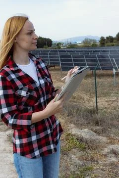 Female engineer using a digital tablet with a stylus, examining the perform.. Foto stock