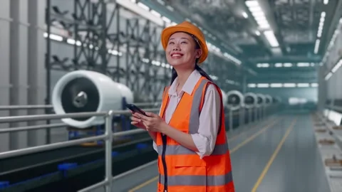 Female Engineer Using Smartphone, Aircraft Engine Factory Stock Footage 314608017