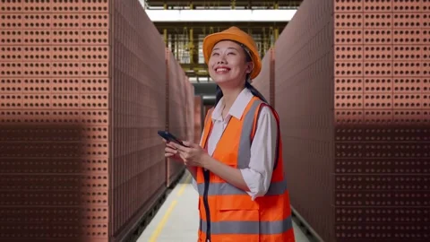 Female Engineer Using Smartphone With Brick In Stacks Stock Footage 303762062