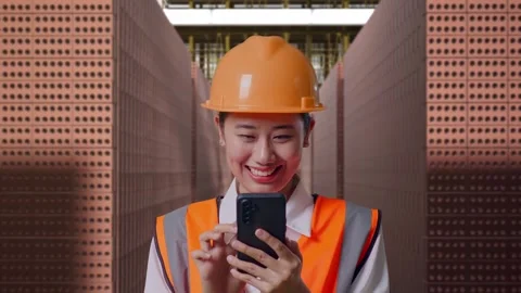 Female Engineer Using Smartphone With Brick In Stacks Stock Footage 303762513