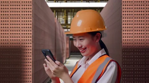 Female Engineer Using Smartphone With Brick In Stacks Stock Footage 303762655