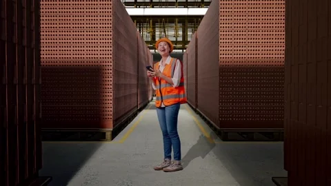 Female Engineer Using Smartphone With Brick In Stacks Stock Footage 303763445