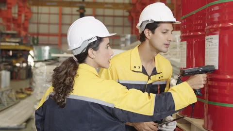 Female engineer utilizes a barcode scanner on industrial products Stock Footage 248017532