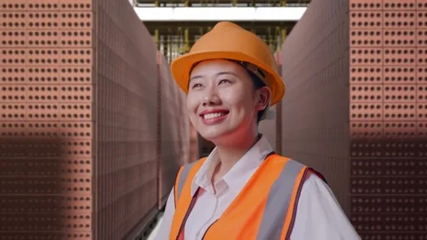 Female Engineer While Standing With Arms Akimbo With Brick In Stacks Stock Footage 303762553