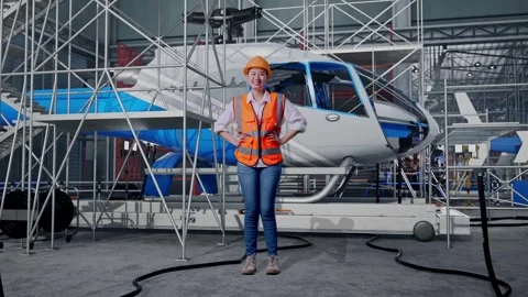 Female Engineer While Standing With Arms Akimbo and Inspecting Helicopter Stock Footage 312127379