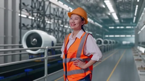 Female Engineer While Standing With Arms Akimbo, Aircraft Engine Factory Stock Footage 314607919