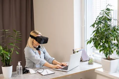 Female engineer working on computer creating a racecar using VR virtual reality Stock Photos