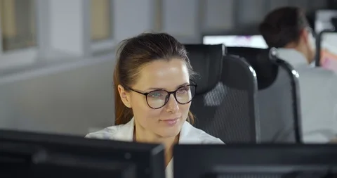 Female engineer working on computer with two monitors Stock Footage 126639915