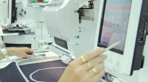 Female engineer working on computerized machine embroidery Stock Footage 31758851