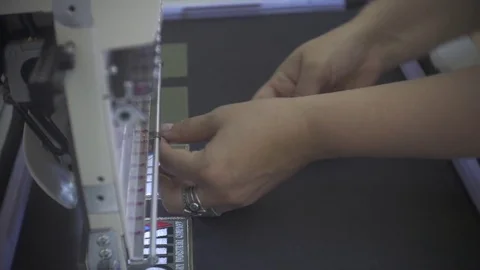Female engineer working on computerized machine embroidery in a factory Video stock 78386052