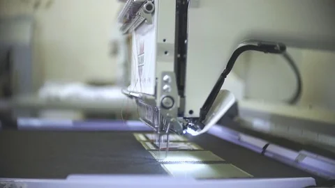 Female engineer working on computerized machine embroidery in a factory Stock Footage 78386238
