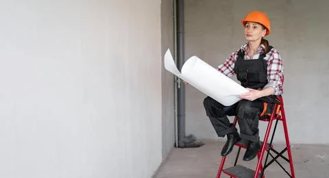 Female engineer working at construction site with project blueprint. Civil En Stock Photos