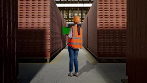 Female Engineer Working On A Green Screen Laptop With Brick In Stacks Stock Footage 303763572