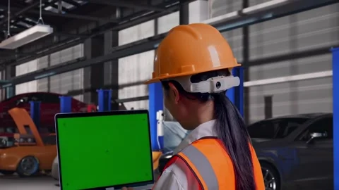 Female Engineer Working On A Green Screen Laptop in Auto Repair Shop Stock Footage 313529251