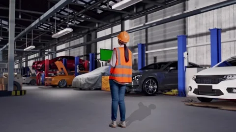 Female Engineer Working On A Green Screen Laptop in Auto Repair Shop Stock Footage 313530521