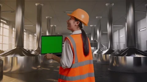 Female Engineer Working On A Green Screen Laptop at Beer Plant Stock Footage 332546571