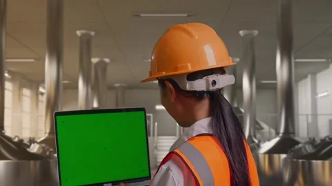 Female Engineer Working On A Green Screen Laptop at Beer Plant Stock Footage 332547377