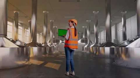 Female Engineer Working On A Green Screen Laptop at Beer Plant Stock Footage 332547935