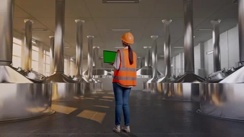 Female Engineer Working On A Green Screen Laptop at Beer Plant Stock Footage 332548481