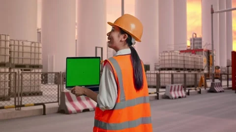 Female Engineer Working On A Green Screen Laptop at Storage Facility Stock Footage 337754097